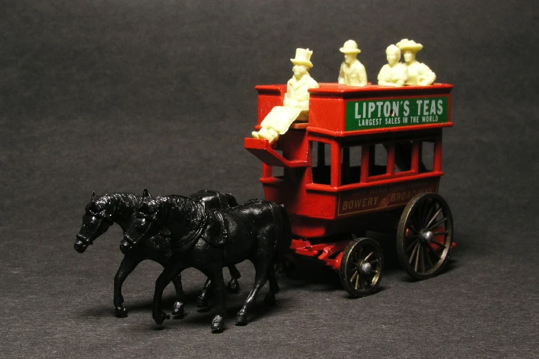 the toy horse and carriage are near the black toy