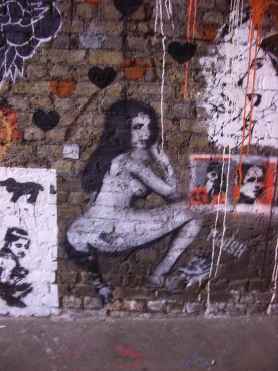 a graffiti of a woman seated with some other items