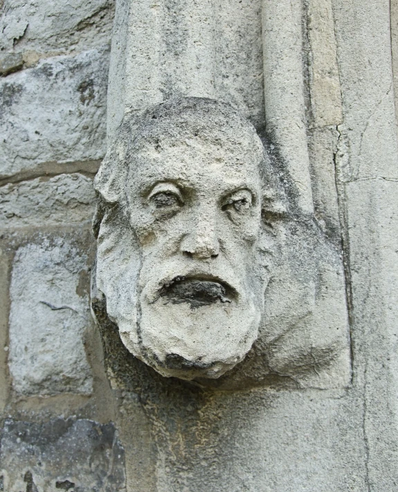 the face is carved on a stone wall