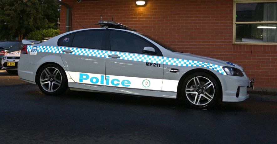 a police car is parked near the curb