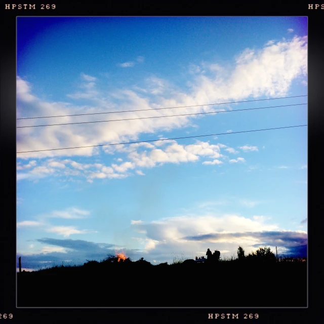 the power lines are connected to a bright sky