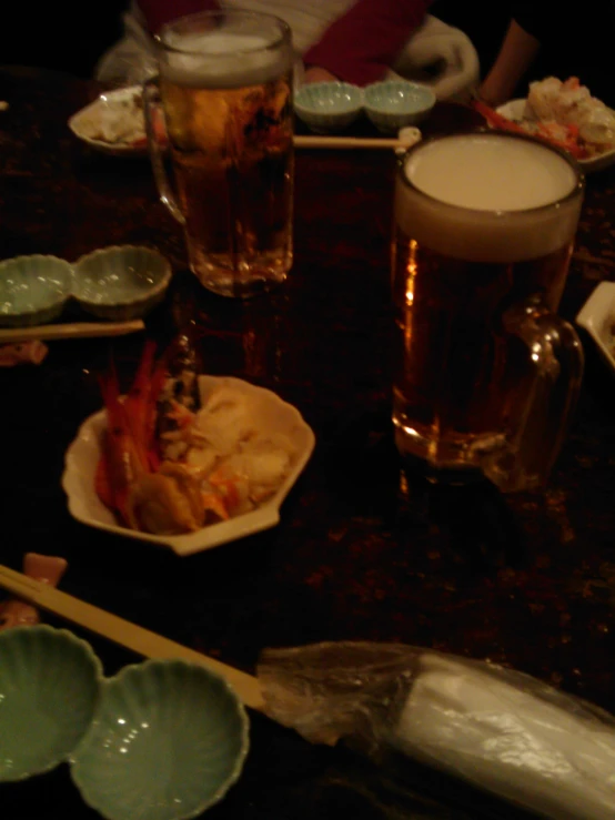 a bowl of food and a cup of beer on a table