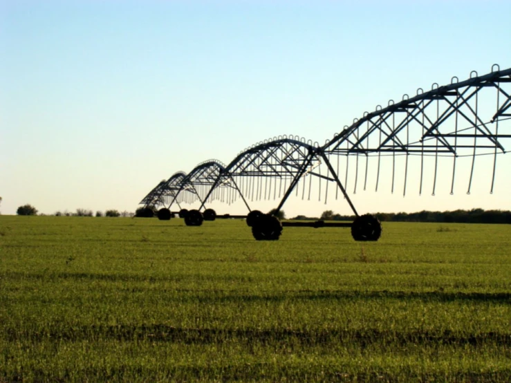 large sprinkles are installed in an open field