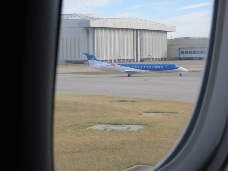 a window looking out on an airplane on the runway