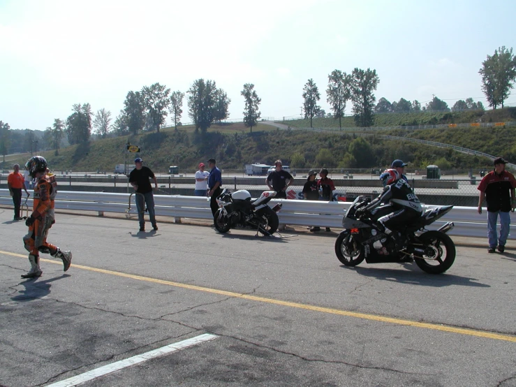 group of people crossing the street on motorcycles