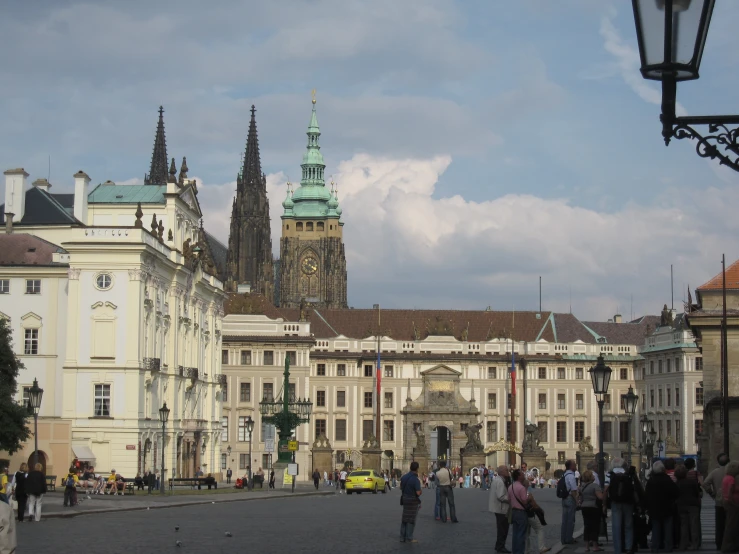 a bunch of people standing in front of some buildings