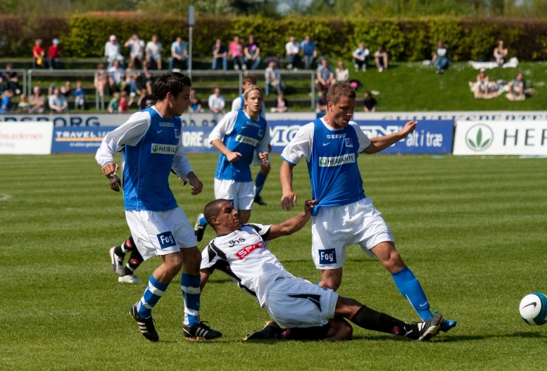 a group of people are on the field playing soccer