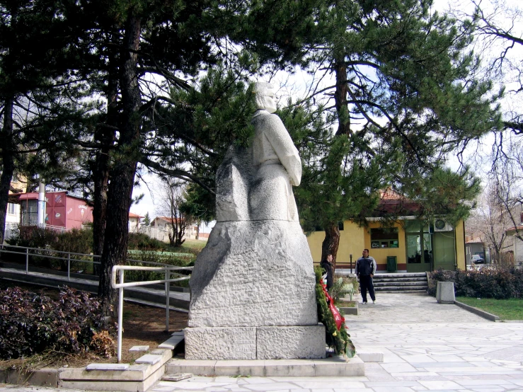 a large, slender figure in the middle of the city park