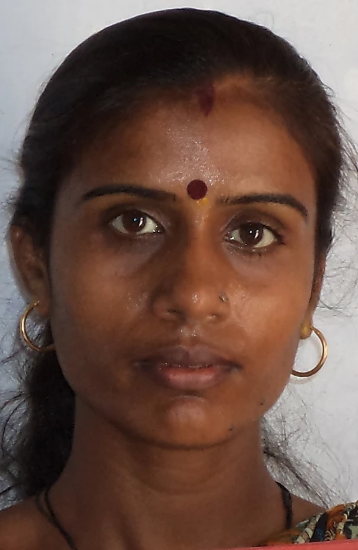 an indian woman with a red blouse and a red flower