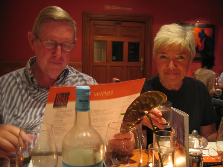 a man and woman sitting at a dinner table