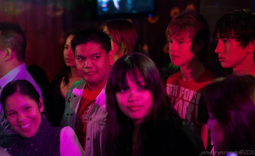 a group of people are sitting together in a crowd