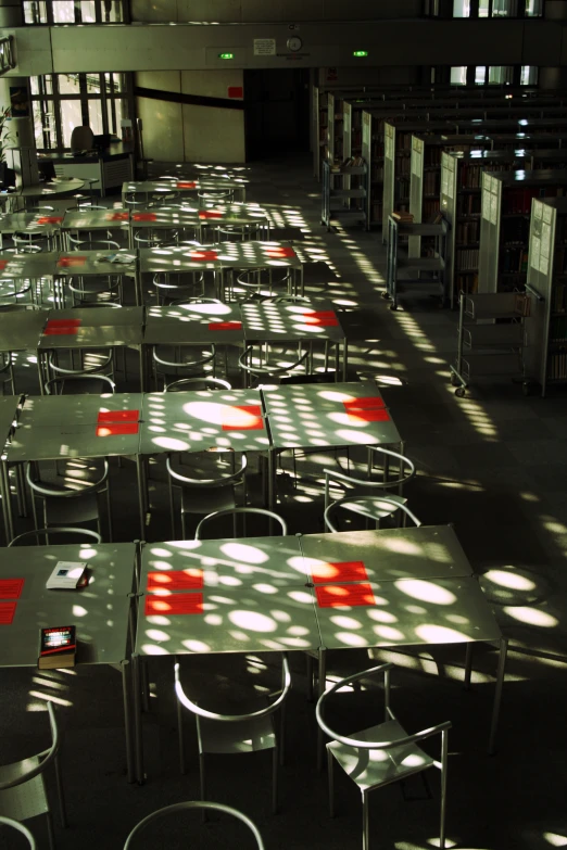 rows of grey tables and chairs in a liry