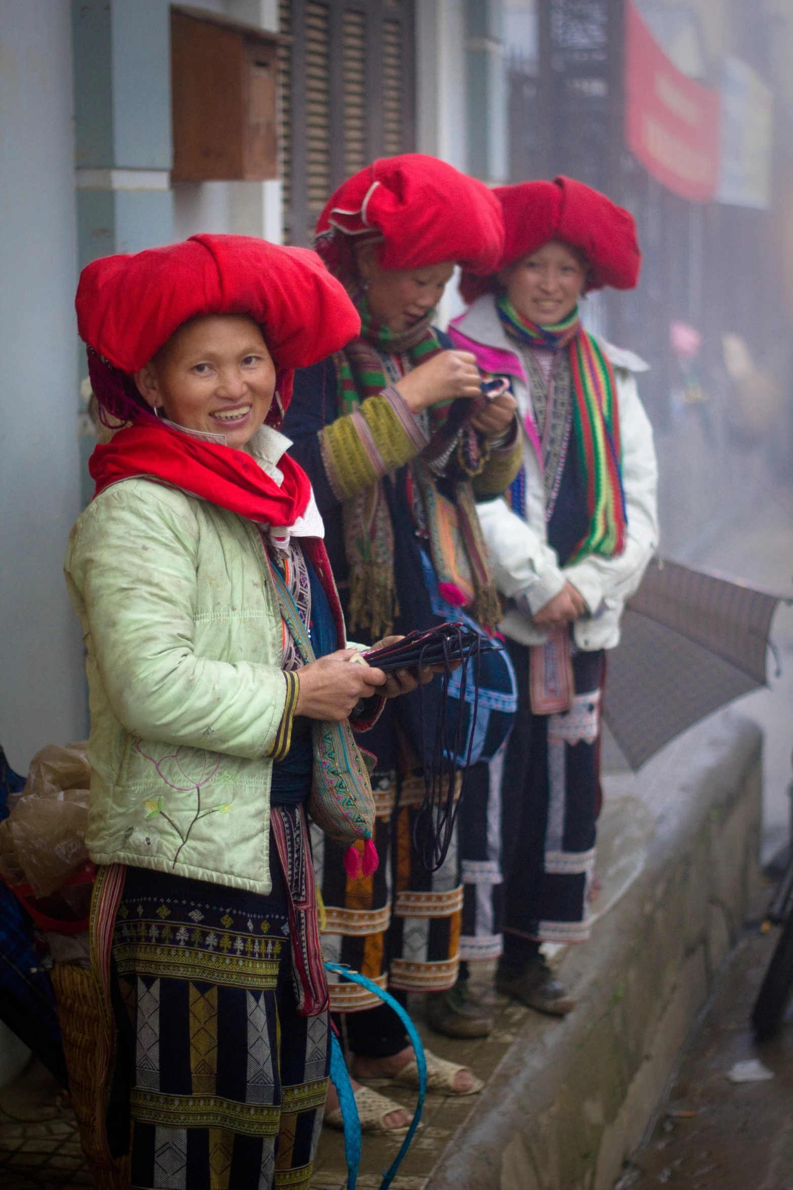 a group of women stand on the street