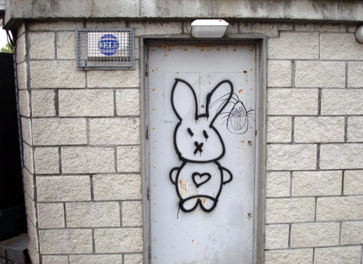 graffiti on the wall of a door depicting a bunny holding a basket