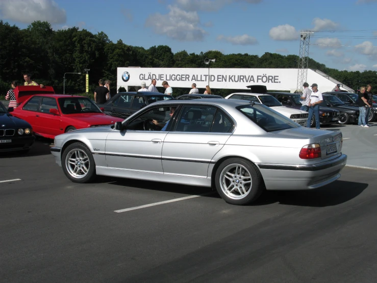 the white car is parked near other cars