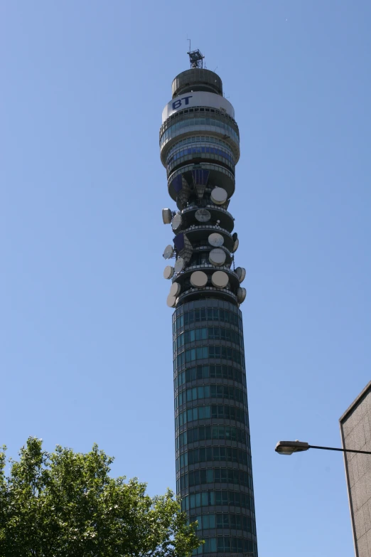 a tall building that has a tower with a bunch of objects