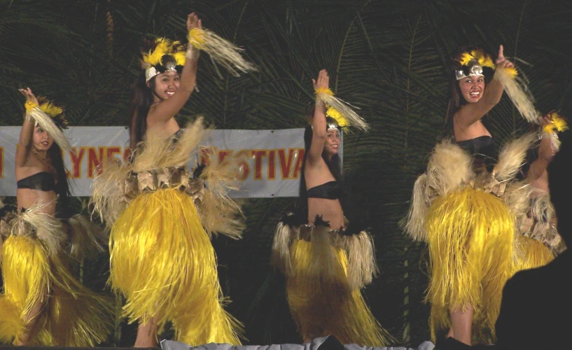 a group of women with headdresses perform a dance