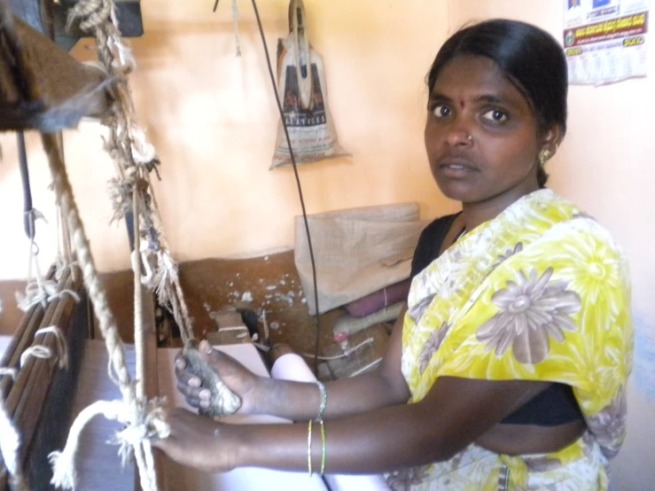 a woman holding soing over the kitchen sink