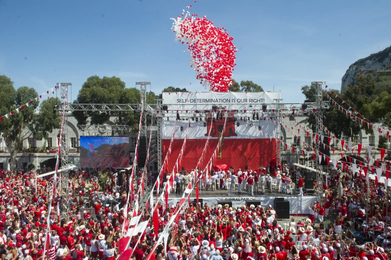 a huge crowd of people wearing red and white