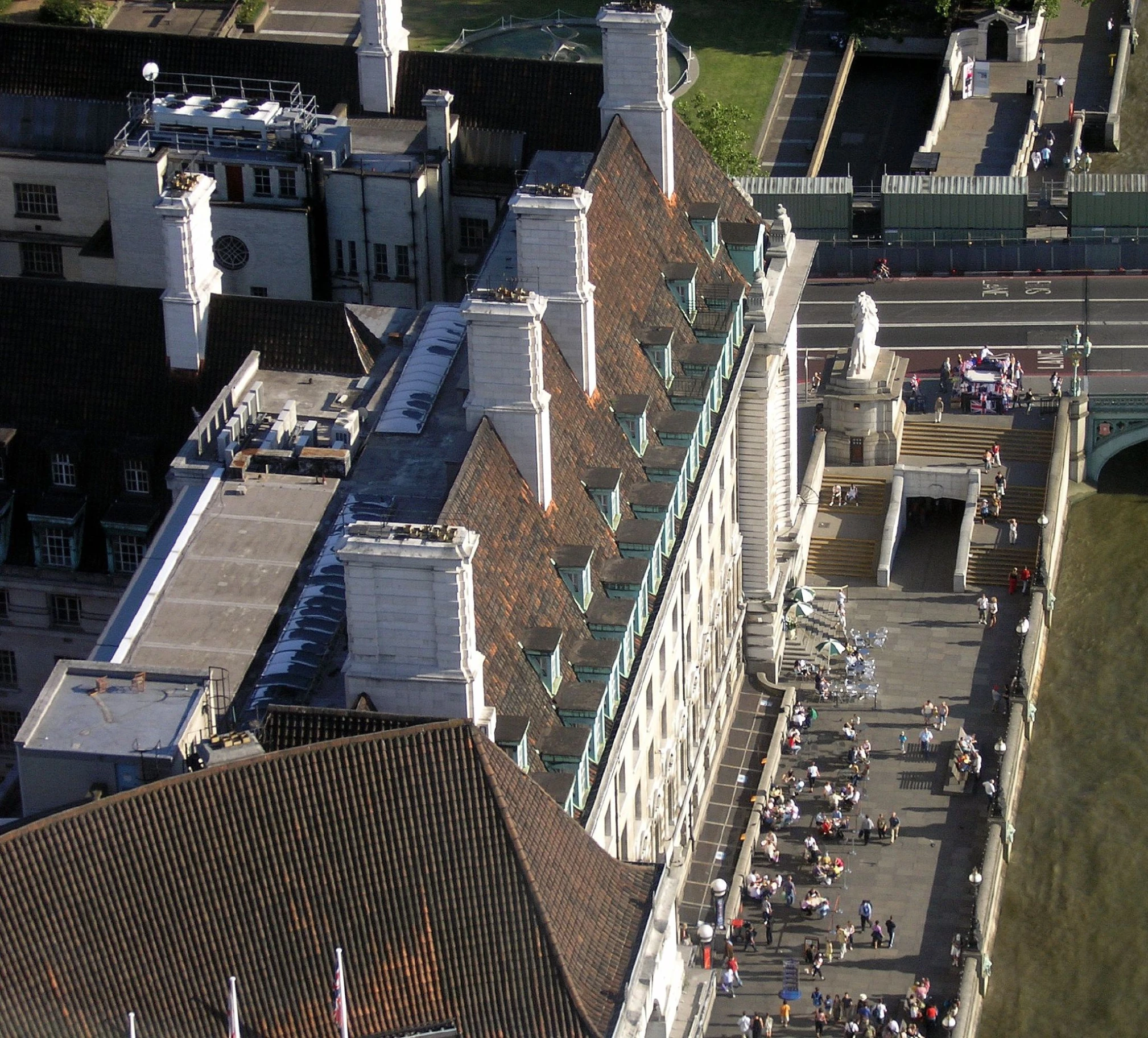 a group of people sitting on top of a tall building