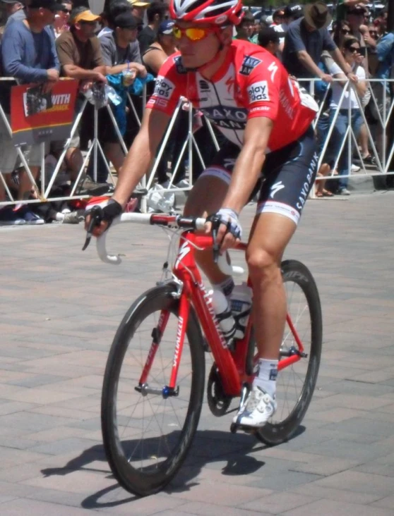 a bicyclist is racing down a brick path