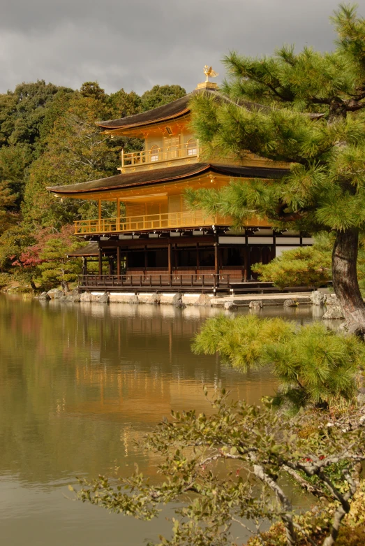 there is an image of a japanese building on the shore