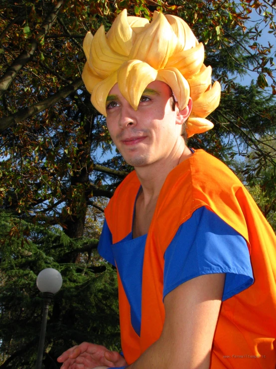 a guy in an orange and blue costume with a yellow hat on his head
