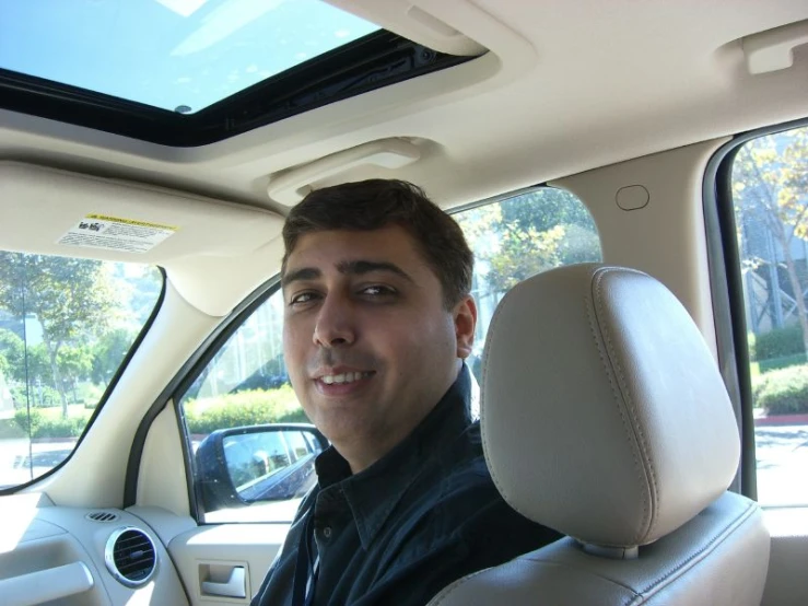 a man sitting in the drivers seat of a vehicle