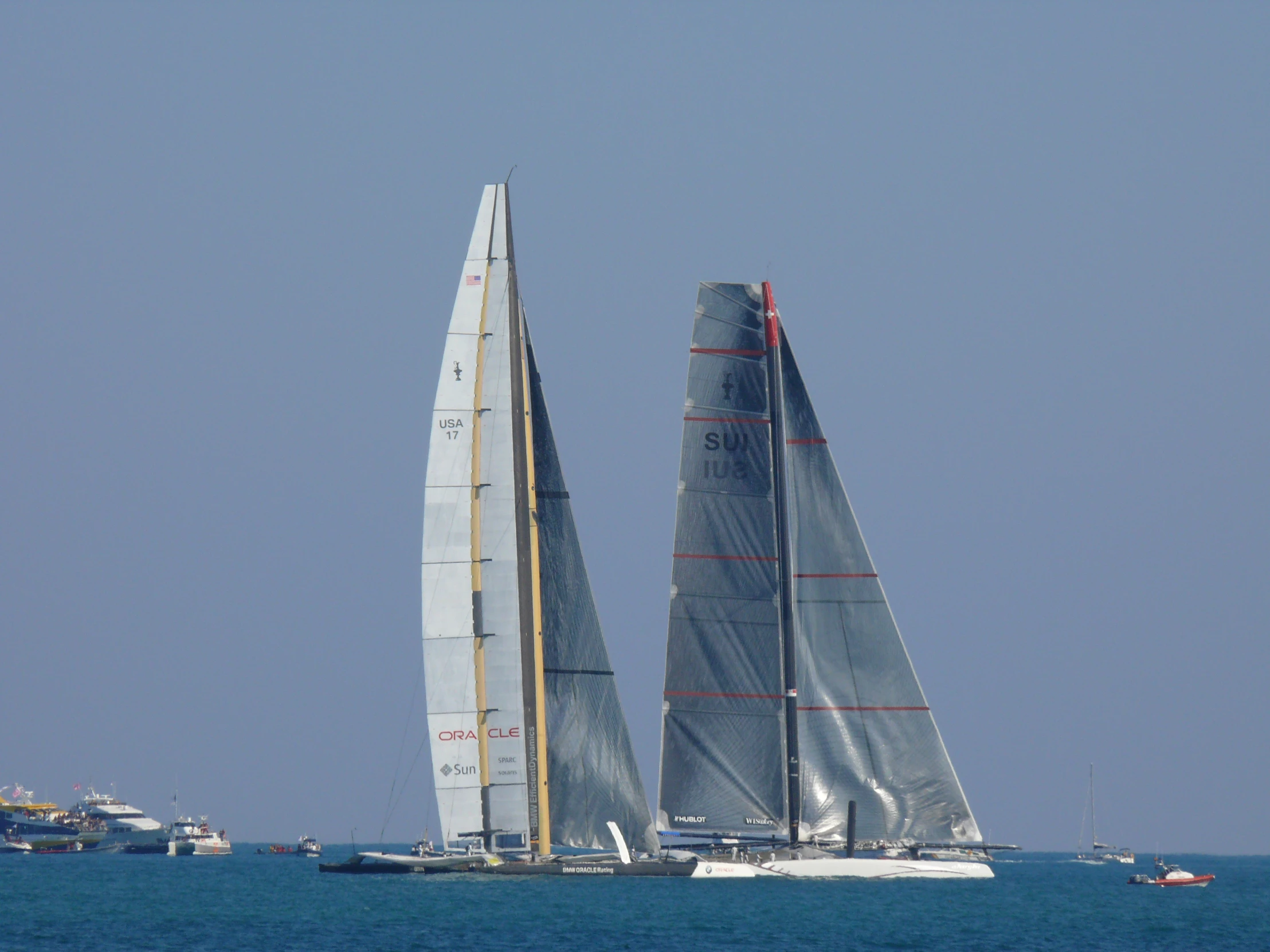 a couple of sailboats in the middle of the ocean