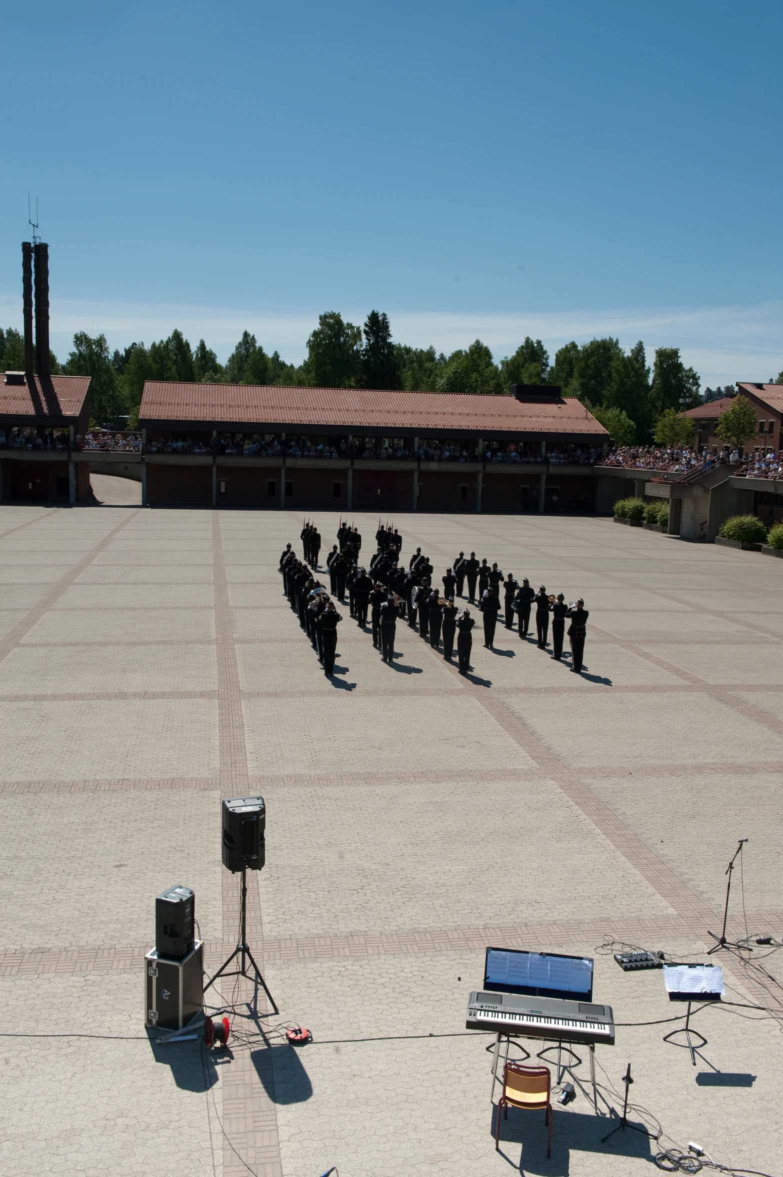 a group of people stand around singing and recording on stage