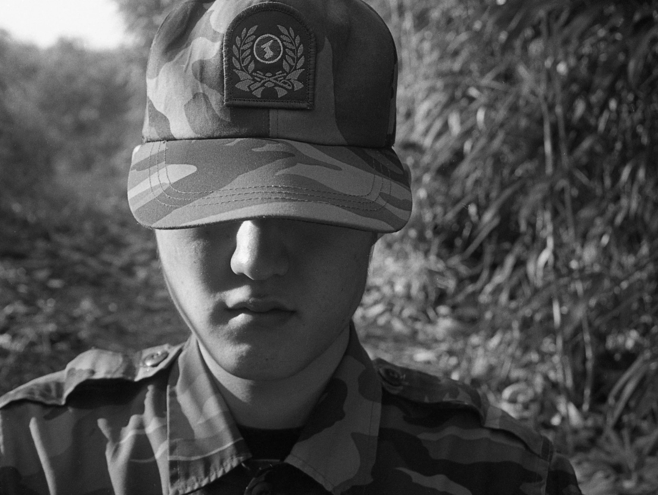 a young man wearing a hat and striped jacket