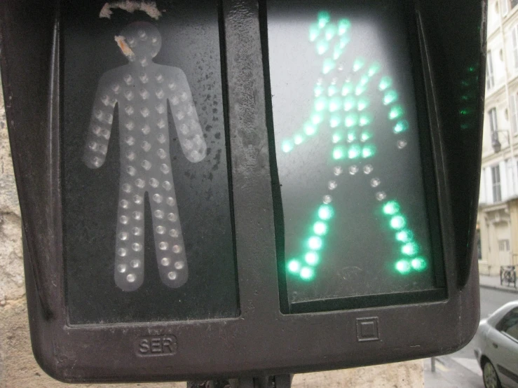 some street signs are green while two people walk