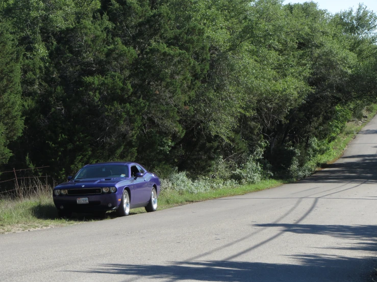 a blue police car parked on the side of the road