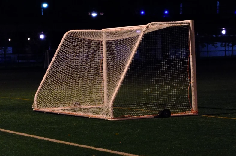 a soccer goal on a field during night