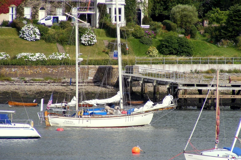 a harbor with sailboats moored to the dock