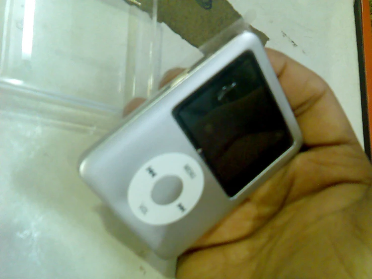 an image of a person holding a broken mp3 player