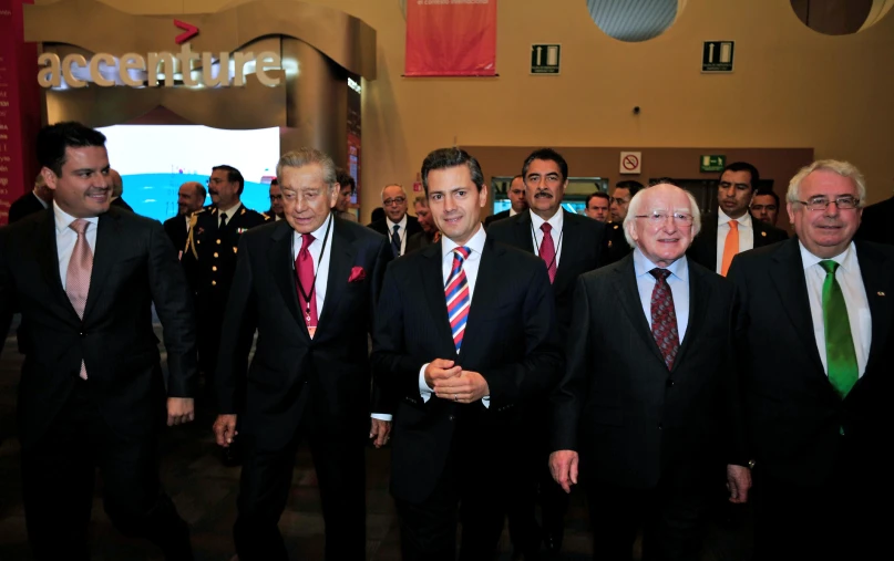 men in suits and ties stand in a group