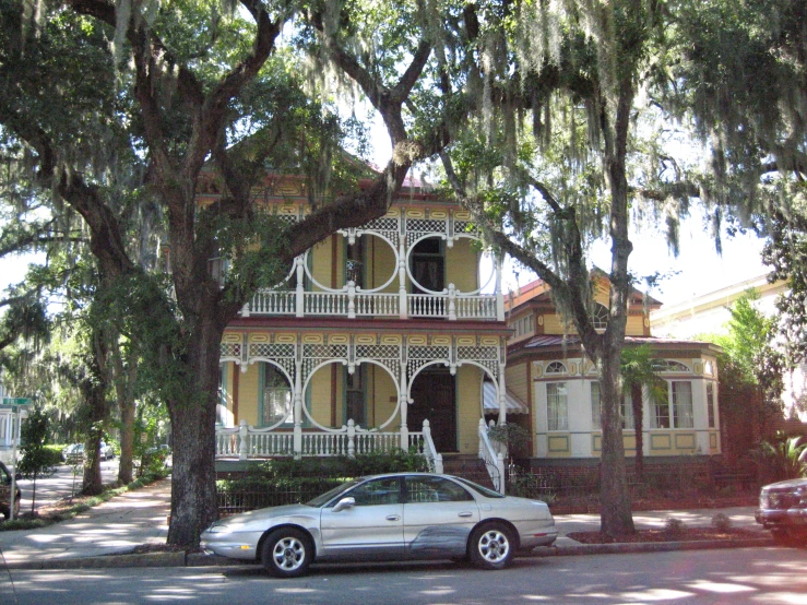 the car is parked on the road in front of the house