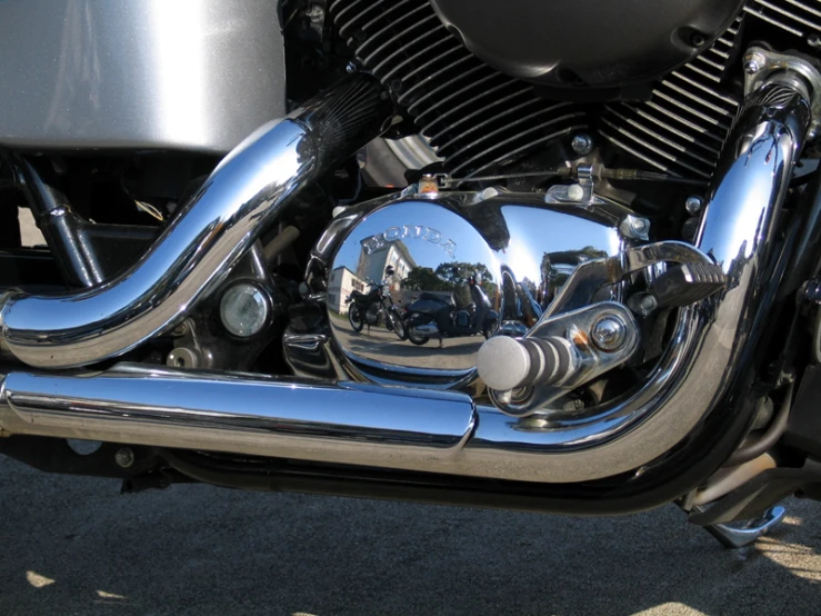 chrome rear pipes of a motorcycle, reflecting the sky