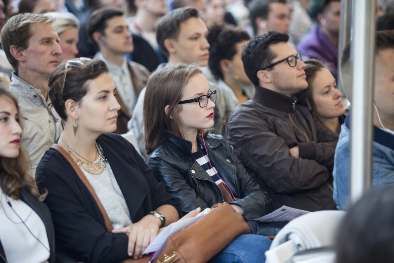 a group of people are waiting in the audience