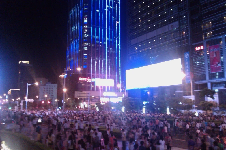 a crowd in a big city, gathered to get their picture taken