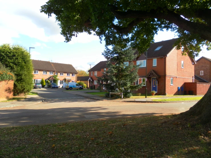 houses and a parking lot seen from the sidewalk