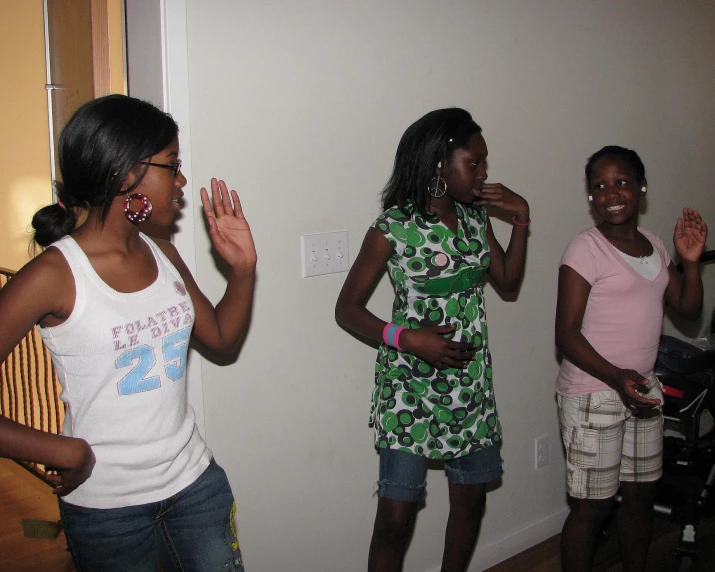 a group of three girls standing next to each other