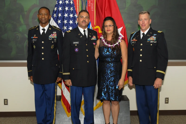 two men in army uniforms and a woman in a blue dress