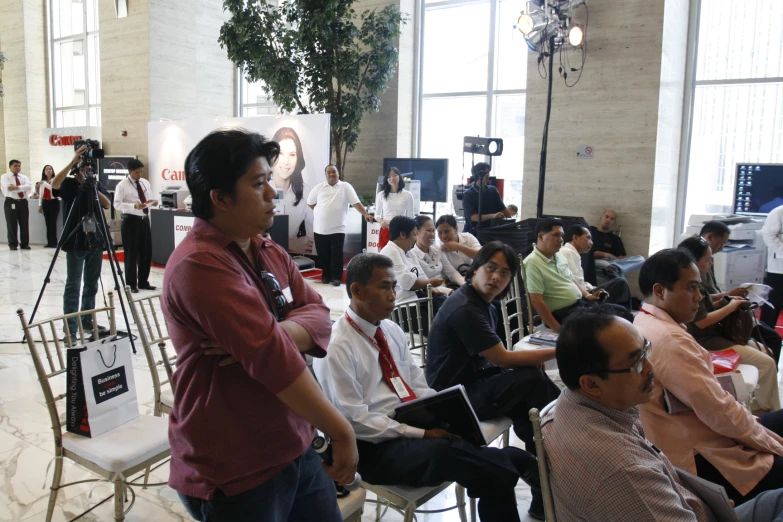 a group of people watching a presentation on a computer screen