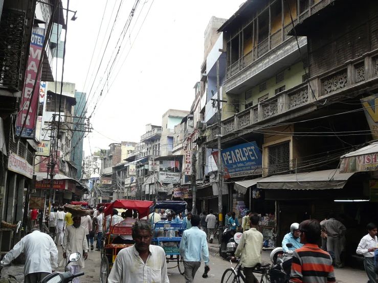 a busy city street is busy with lots of pedestrians