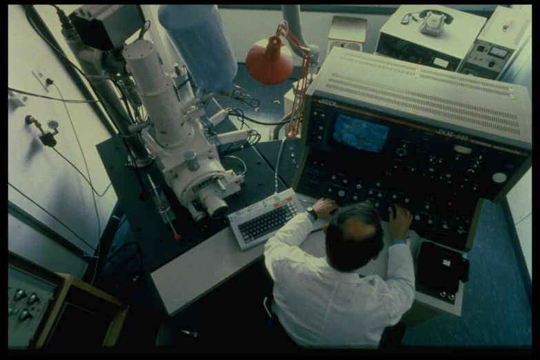 man with laptop working in lab area on machine