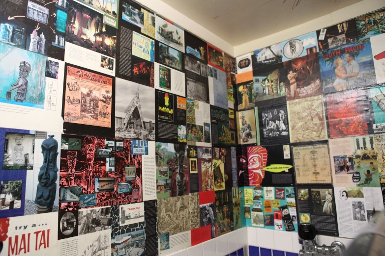 a wall full of poster and pictures are shown