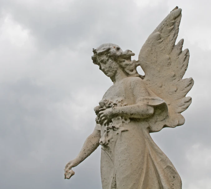 a large statue of a woman holding a flower in her hand