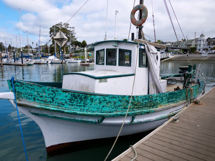 a boat parked in a dock next to a water way